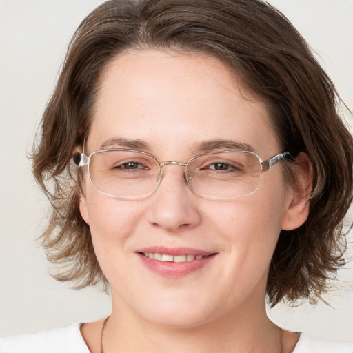 Joyful white adult female with medium  brown hair and grey eyes