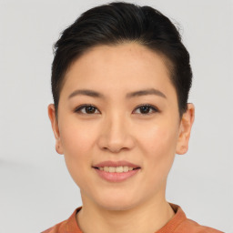 Joyful asian young-adult female with short  brown hair and brown eyes