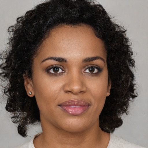Joyful black young-adult female with medium  black hair and brown eyes