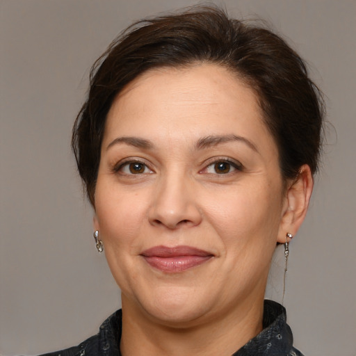 Joyful white adult female with medium  brown hair and brown eyes