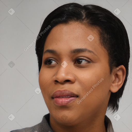 Joyful black young-adult female with short  black hair and brown eyes