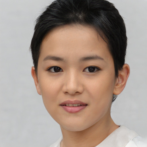 Joyful asian young-adult female with short  brown hair and brown eyes