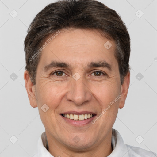 Joyful white adult male with short  brown hair and brown eyes