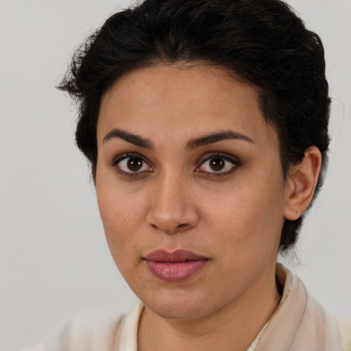 Joyful latino young-adult female with short  brown hair and brown eyes