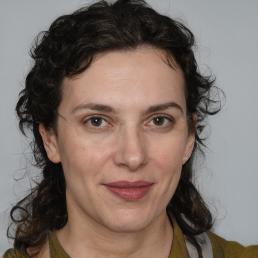 Joyful white adult female with medium  brown hair and green eyes