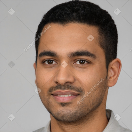 Joyful latino young-adult male with short  black hair and brown eyes