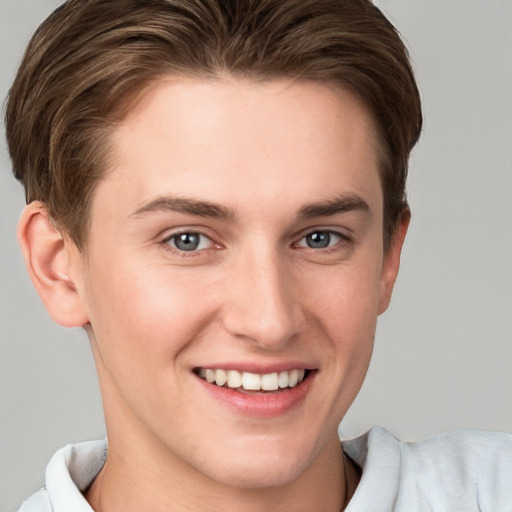 Joyful white young-adult female with short  brown hair and grey eyes