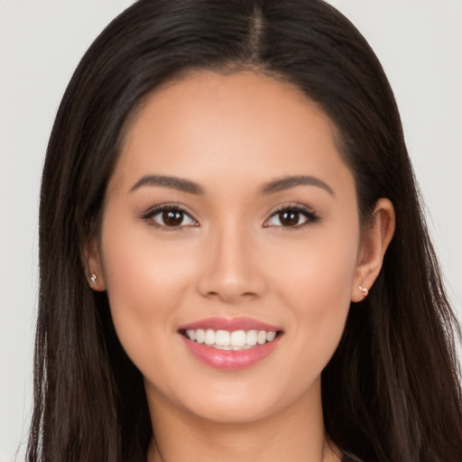 Joyful white young-adult female with long  black hair and brown eyes