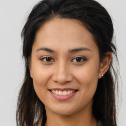 Joyful asian young-adult female with long  brown hair and brown eyes