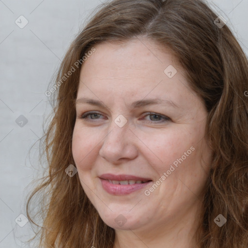 Joyful white adult female with long  brown hair and brown eyes