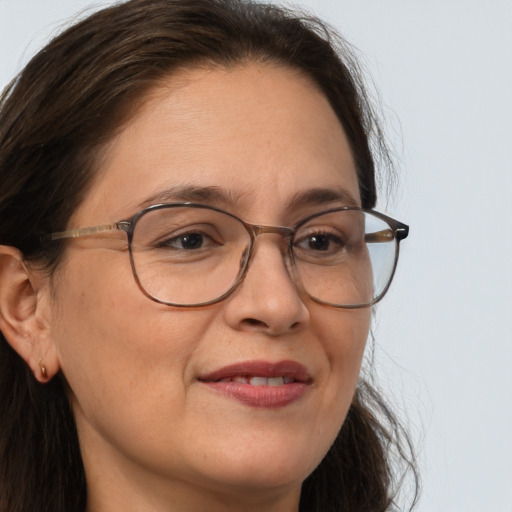 Joyful white adult female with long  brown hair and brown eyes