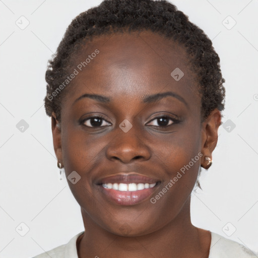 Joyful black young-adult female with short  brown hair and brown eyes