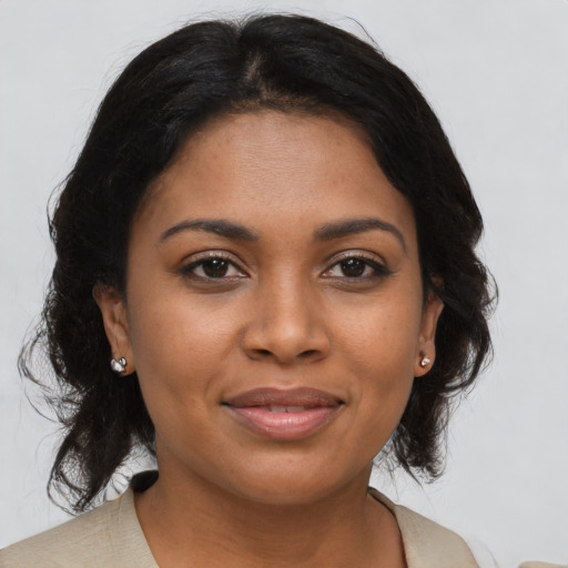 Joyful black young-adult female with medium  brown hair and brown eyes