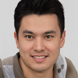 Joyful asian young-adult male with short  brown hair and brown eyes