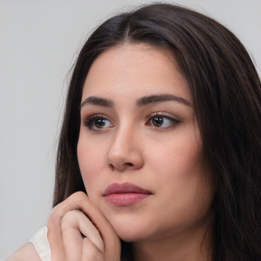 Neutral white young-adult female with long  brown hair and brown eyes