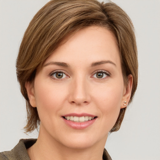 Joyful white young-adult female with medium  brown hair and grey eyes