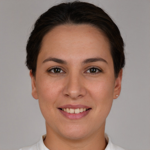 Joyful white young-adult female with short  brown hair and brown eyes