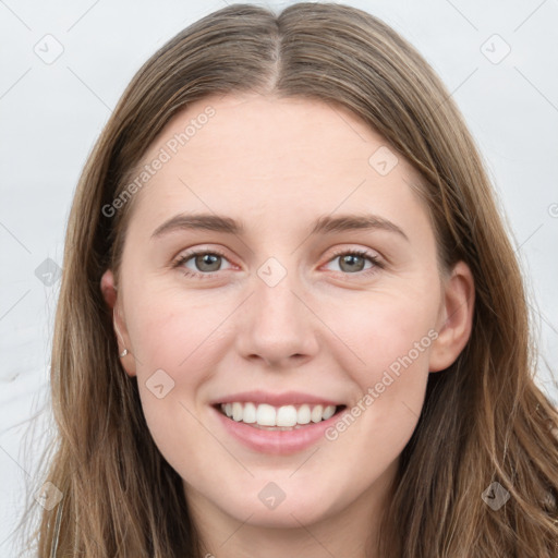 Joyful white young-adult female with long  brown hair and grey eyes