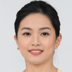 Joyful asian young-adult female with medium  brown hair and brown eyes