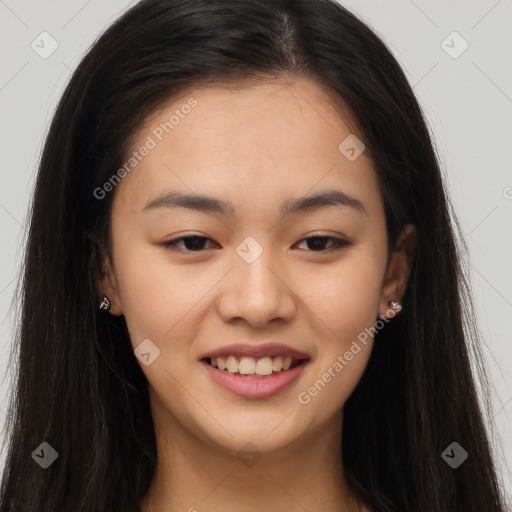 Joyful asian young-adult female with long  brown hair and brown eyes