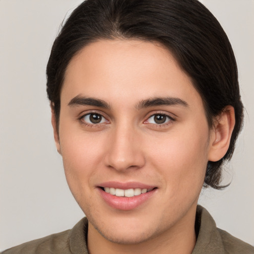 Joyful white young-adult female with medium  brown hair and brown eyes