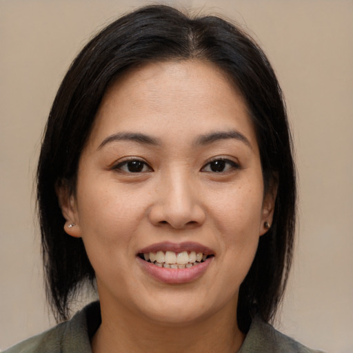 Joyful asian young-adult female with medium  brown hair and brown eyes