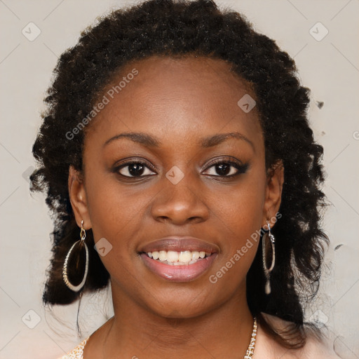 Joyful black young-adult female with long  brown hair and brown eyes