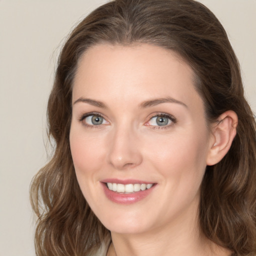 Joyful white young-adult female with medium  brown hair and green eyes