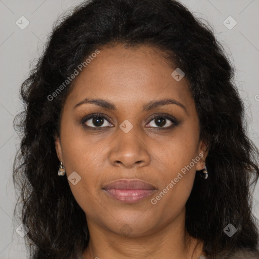 Joyful black young-adult female with long  brown hair and brown eyes