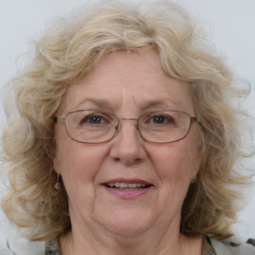 Joyful white middle-aged female with medium  brown hair and blue eyes