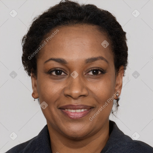 Joyful black adult female with short  brown hair and brown eyes