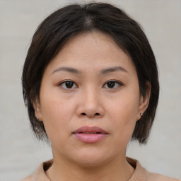 Neutral asian young-adult female with medium  brown hair and brown eyes