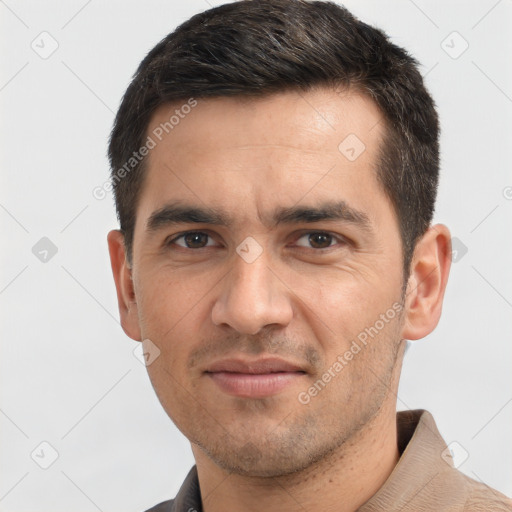 Joyful white adult male with short  black hair and brown eyes