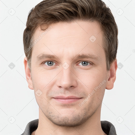 Joyful white young-adult male with short  brown hair and grey eyes