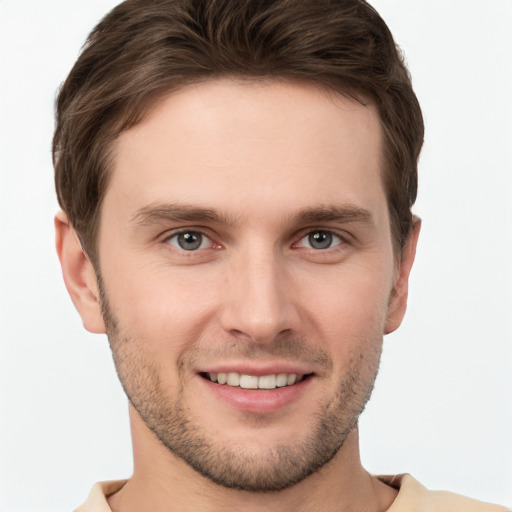 Joyful white young-adult male with short  brown hair and grey eyes