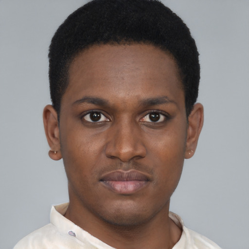 Joyful black young-adult male with short  brown hair and brown eyes