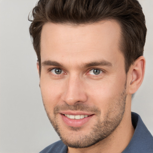 Joyful white young-adult male with short  brown hair and brown eyes