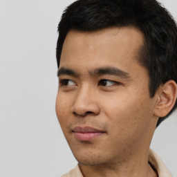 Joyful asian young-adult male with short  black hair and brown eyes