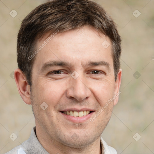 Joyful white adult male with short  brown hair and brown eyes