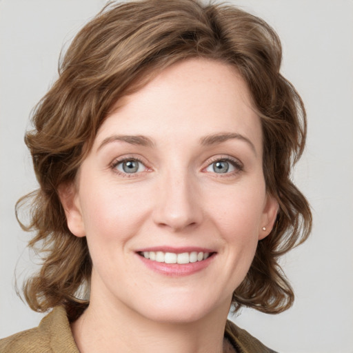 Joyful white young-adult female with medium  brown hair and blue eyes