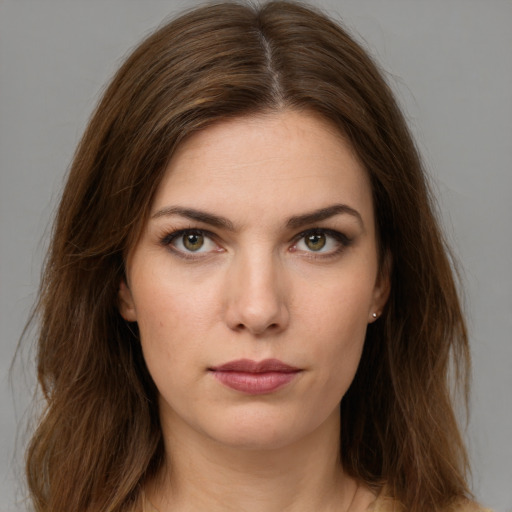 Neutral white young-adult female with long  brown hair and green eyes