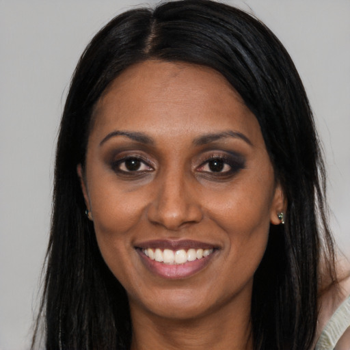Joyful latino adult female with long  brown hair and brown eyes