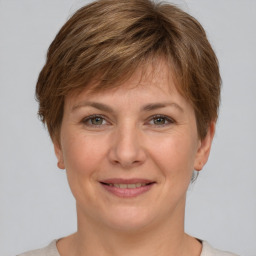 Joyful white adult female with short  brown hair and grey eyes