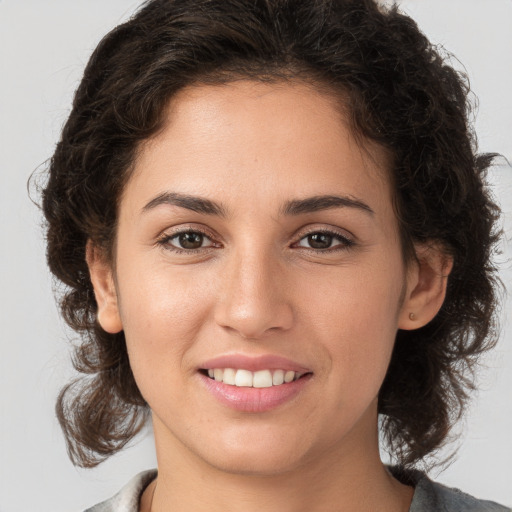 Joyful white young-adult female with medium  brown hair and brown eyes