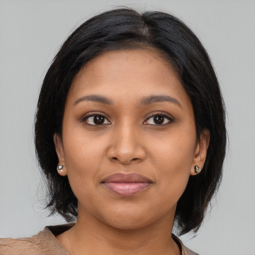 Joyful latino young-adult female with medium  brown hair and brown eyes