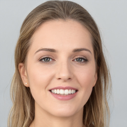 Joyful white young-adult female with long  brown hair and grey eyes