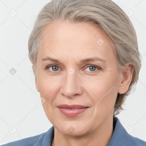 Joyful white adult female with medium  brown hair and grey eyes