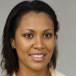 Joyful latino young-adult female with medium  brown hair and brown eyes