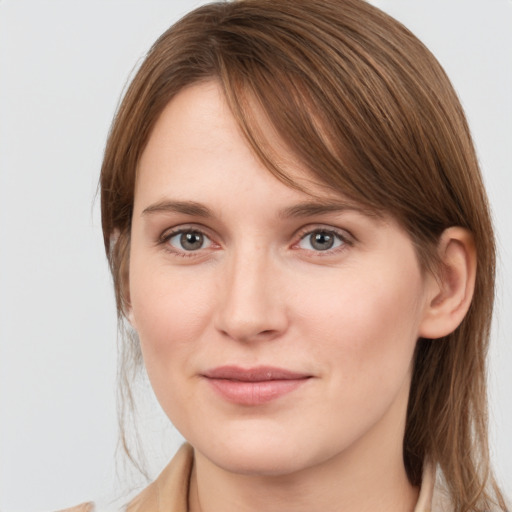 Joyful white young-adult female with medium  brown hair and grey eyes