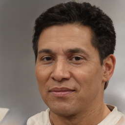 Joyful white adult male with short  black hair and brown eyes